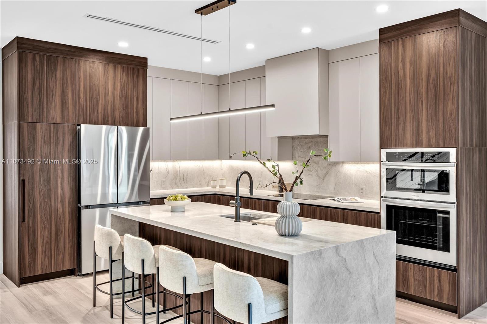 1387 Southwest 22nd Terrace Miami, FL 33145 - Photo 11 of 59 a kitchen with stainless steel appliances a table chairs and a refrigerator