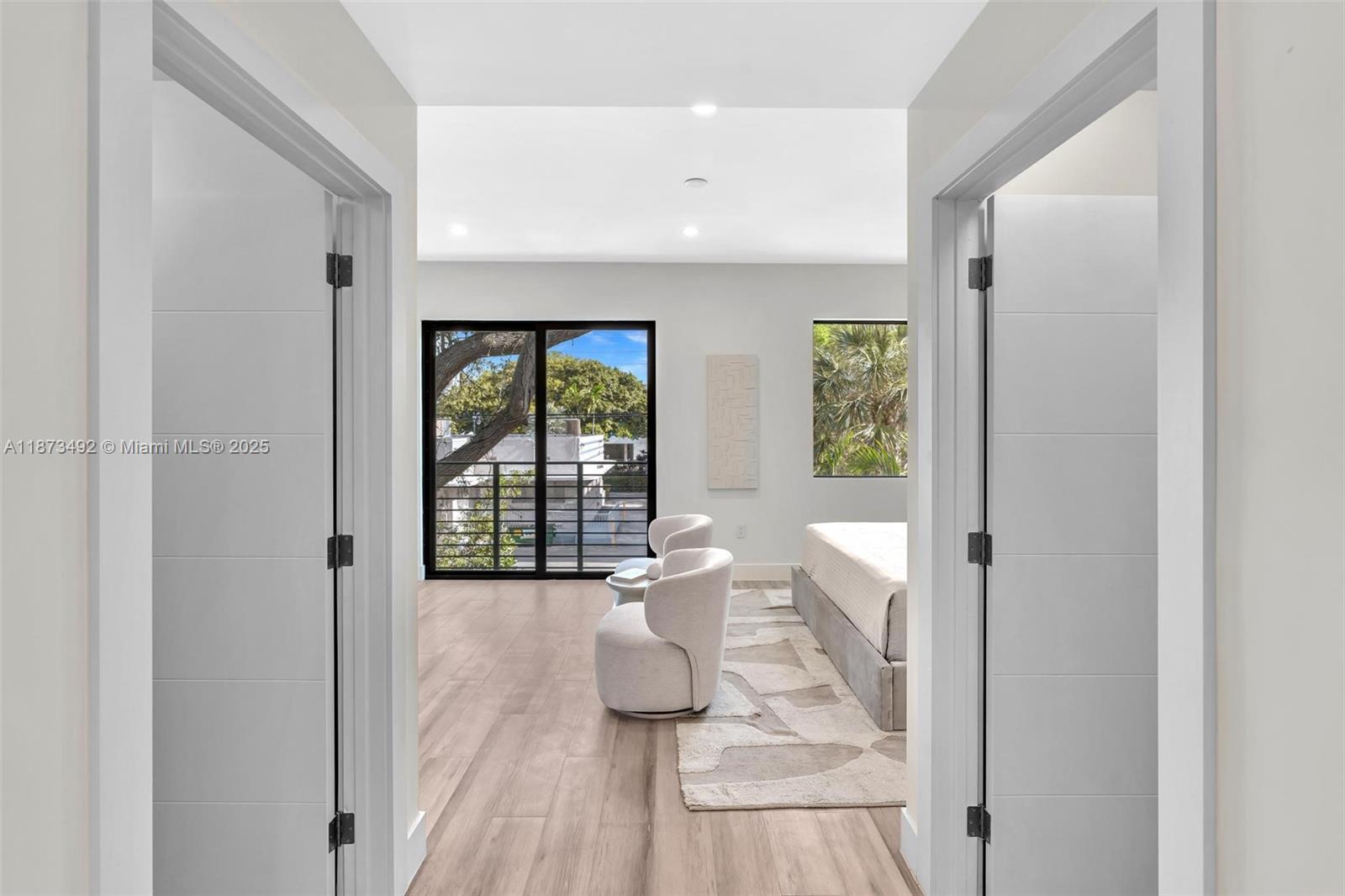 1387 Southwest 22nd Terrace Miami, FL 33145 - Photo 27 of 59 a view of a hallway with wooden floor and a living room