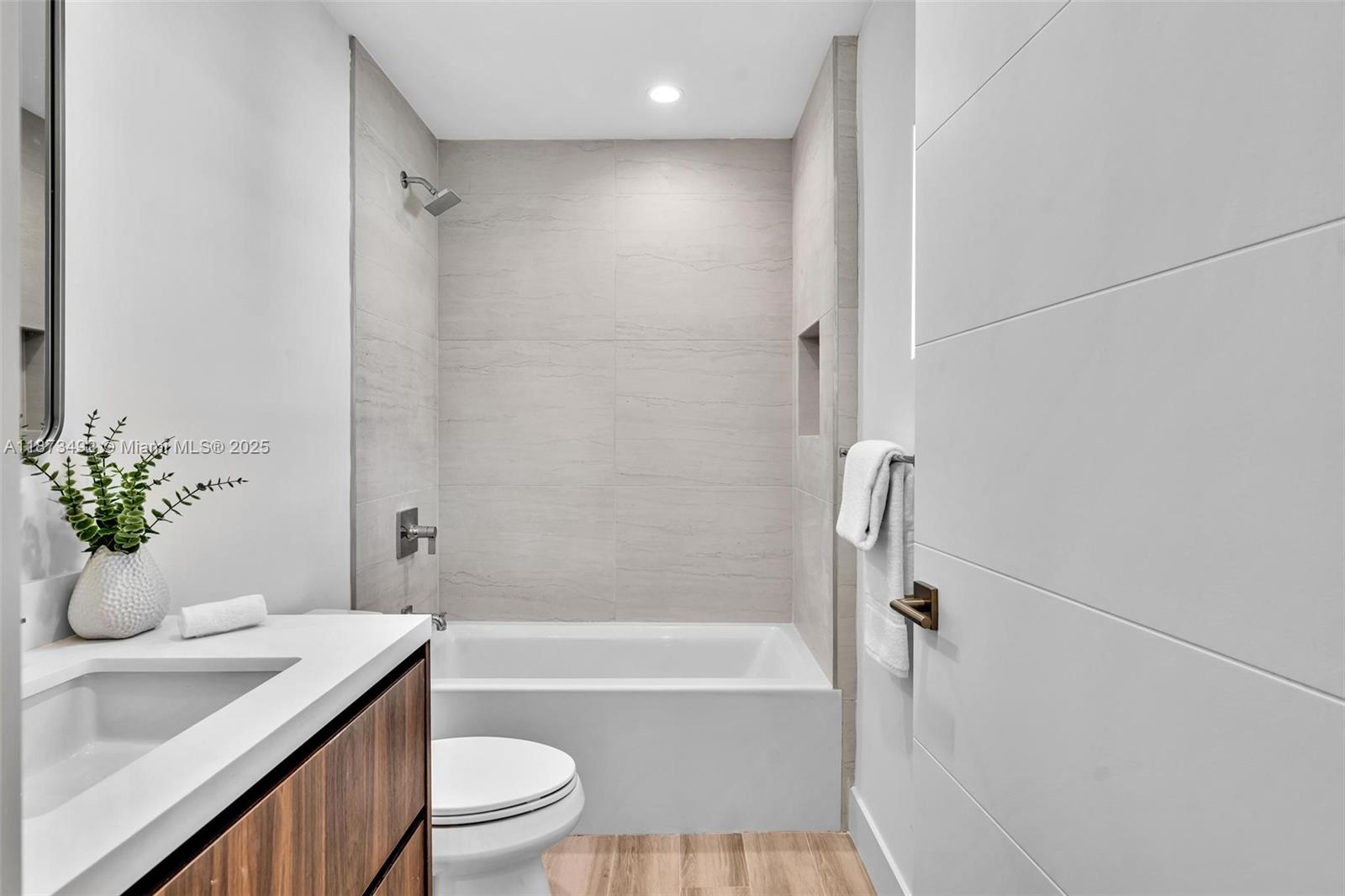 1387 Southwest 22nd Terrace Miami, FL 33145 - Photo 39 of 59 a bathroom with a granite countertop sink a toilet a mirror a vanity and shower