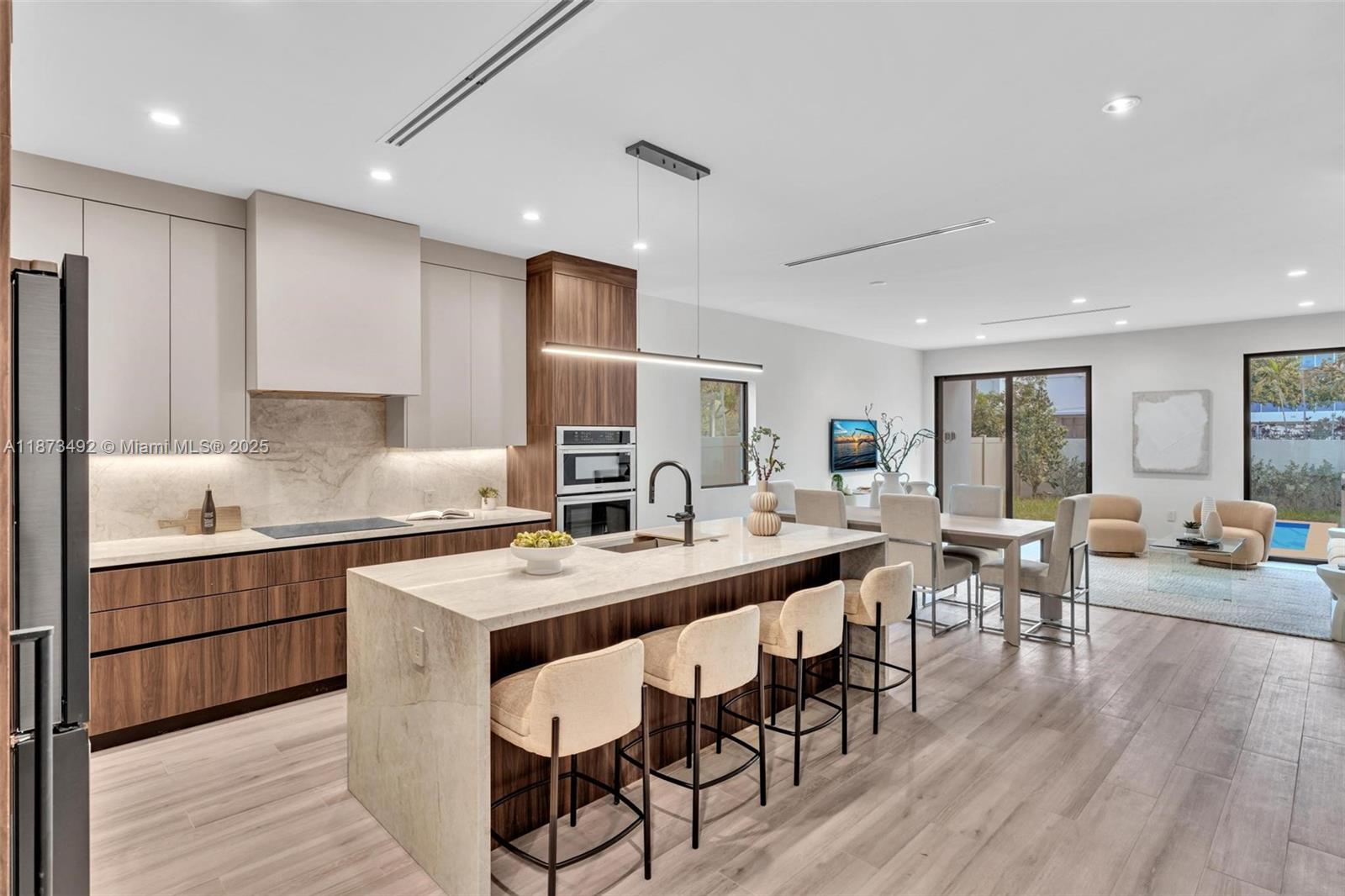 1387 Southwest 22nd Terrace Miami, FL 33145 - Photo 7 of 59 a large kitchen with a table and chairs