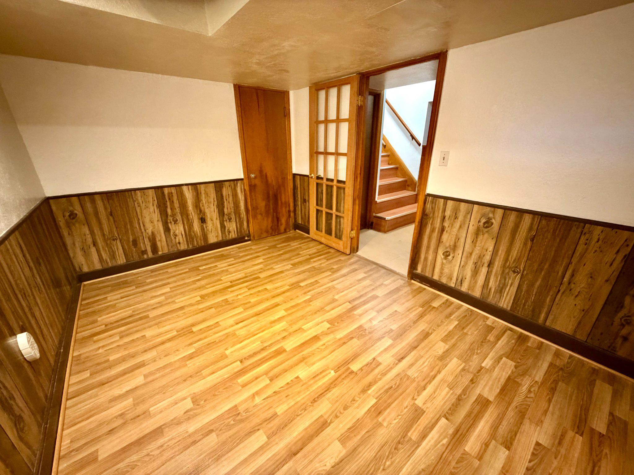 6318 Winner Avenue Baltimore, MD 21215 - Photo 56 of 75 a view of an empty room with wooden floor and a window