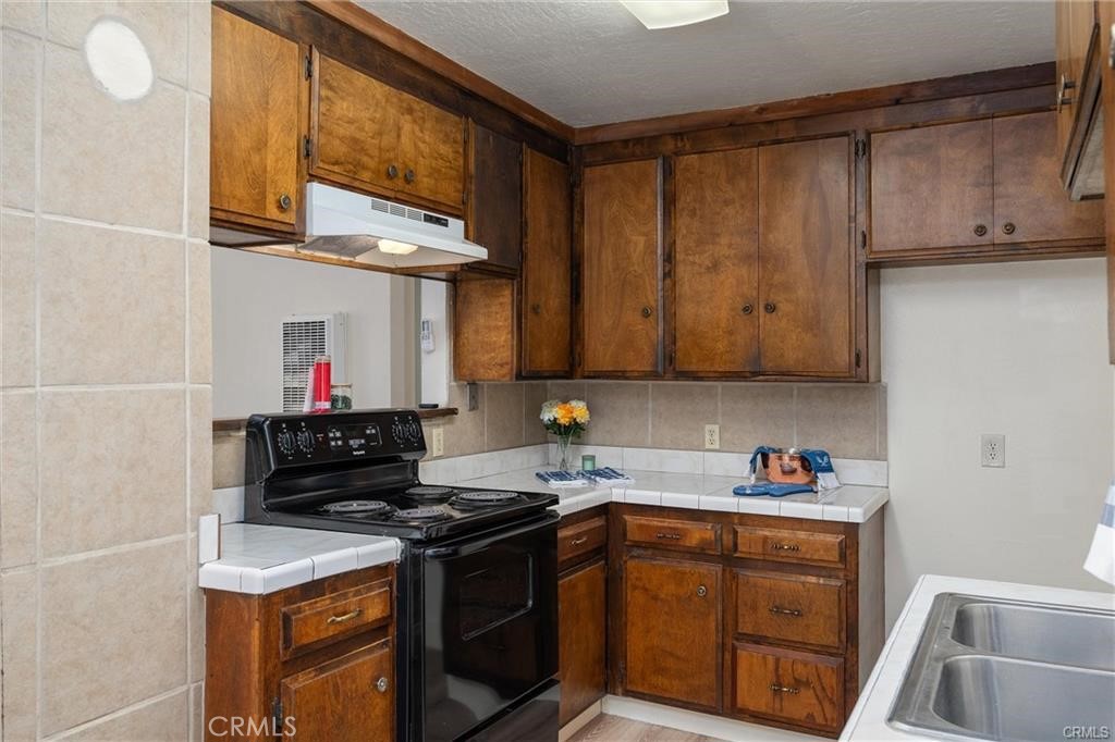 1220 Long Bar Road Oroville, CA 95966 - Photo 12 of 30 a kitchen with stainless steel appliances granite countertop a stove and a microwave