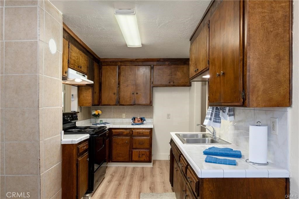 1220 Long Bar Road Oroville, CA 95966 - Photo 6 of 30 a kitchen with a sink stove top oven and cabinets