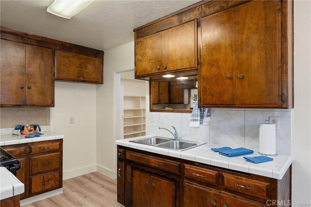 1220 Long Bar Road Oroville, CA 95966 - Photo 10 of 30 a kitchen with stainless steel appliances wooden cabinets and a sink