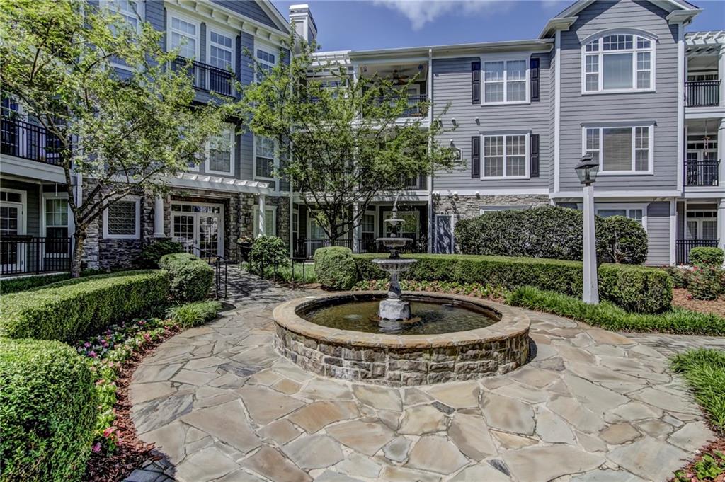 4100 Paces Walk Southeast, Unit 3205 Atlanta, GA 30339 - Photo 16 of 17 a view of a house with a yard and plants