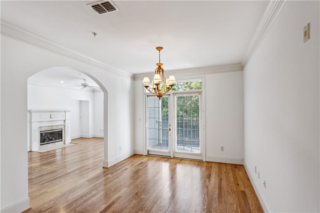 4100 Paces Walk Southeast, Unit 3205 Atlanta, GA 30339 - Photo 6 of 17 an empty room with wooden floor fireplace and windows