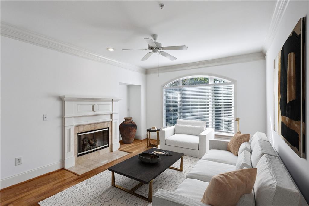 4100 Paces Walk Southeast, Unit 3205 Atlanta, GA 30339 - Photo 7 of 17 a living room with furniture a flat screen tv and a fireplace