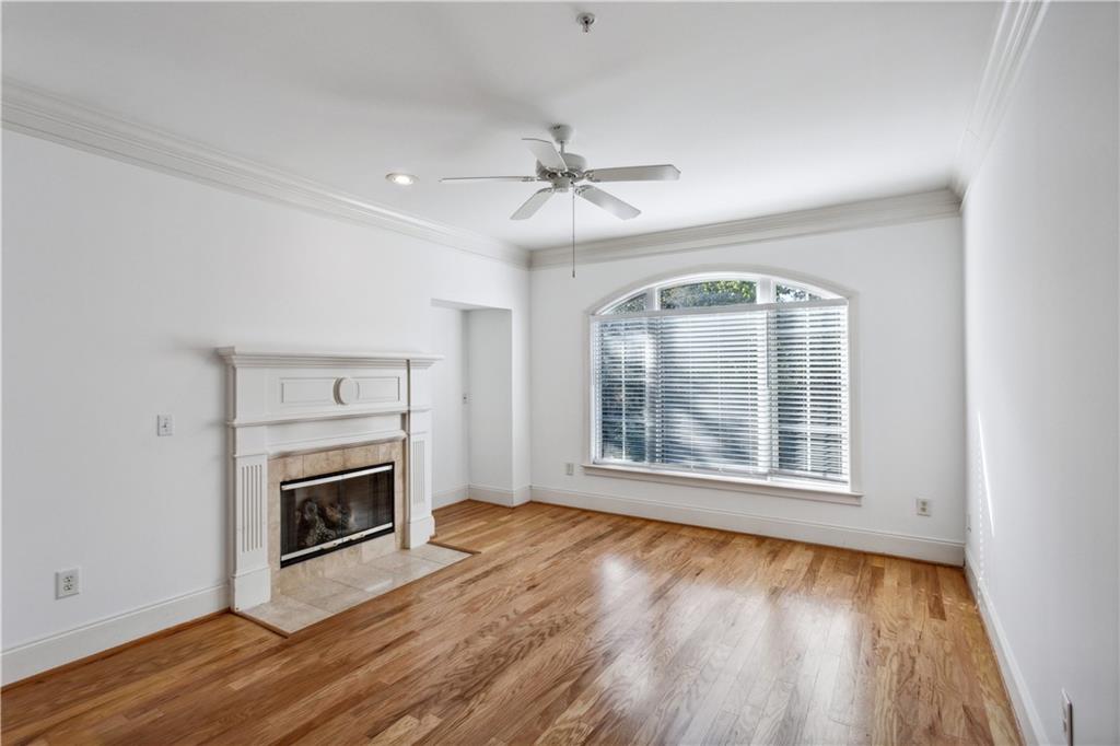 4100 Paces Walk Southeast, Unit 3205 Atlanta, GA 30339 - Photo 8 of 17 an empty room with wooden floor fireplace and windows