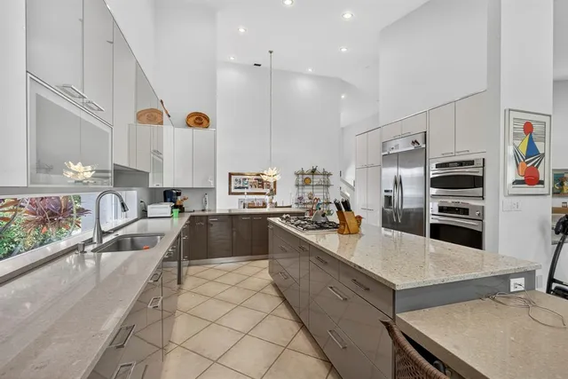 a view of a kitchen and kitchen with stainless steel appliances