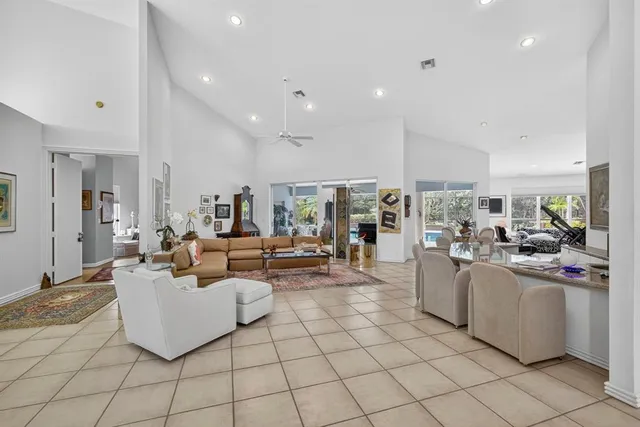a dining room filled chandelier and kitchen view