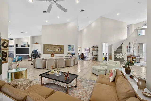 a living room with furniture and view of kitchen