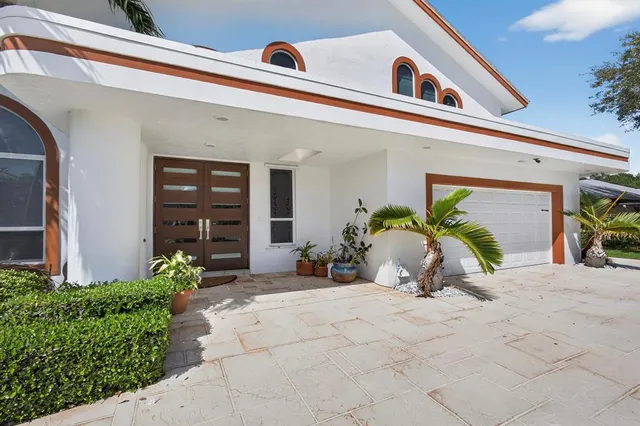 a living room with furniture ceiling fan and a large window