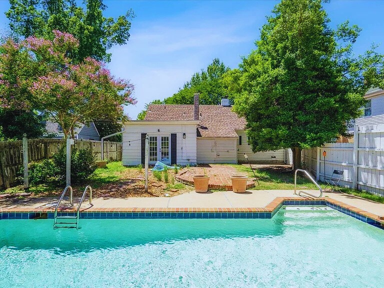 a view of a house with swimming pool and sitting area