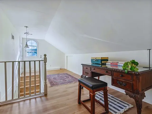 a living room with furniture and paintings on the wall