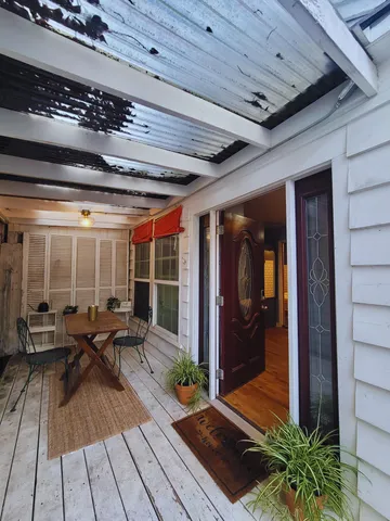 a bedroom with a large bed and a flat tv screen on dresser