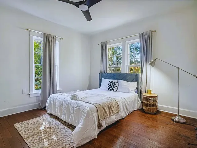 a bedroom with a large bed and a window