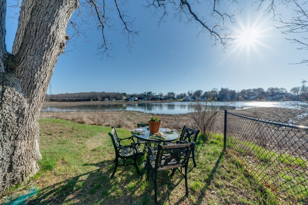 53 Colonial Road Weymouth, MA 02191 - Photo 18 of 19 a view of a lake with table and chairs