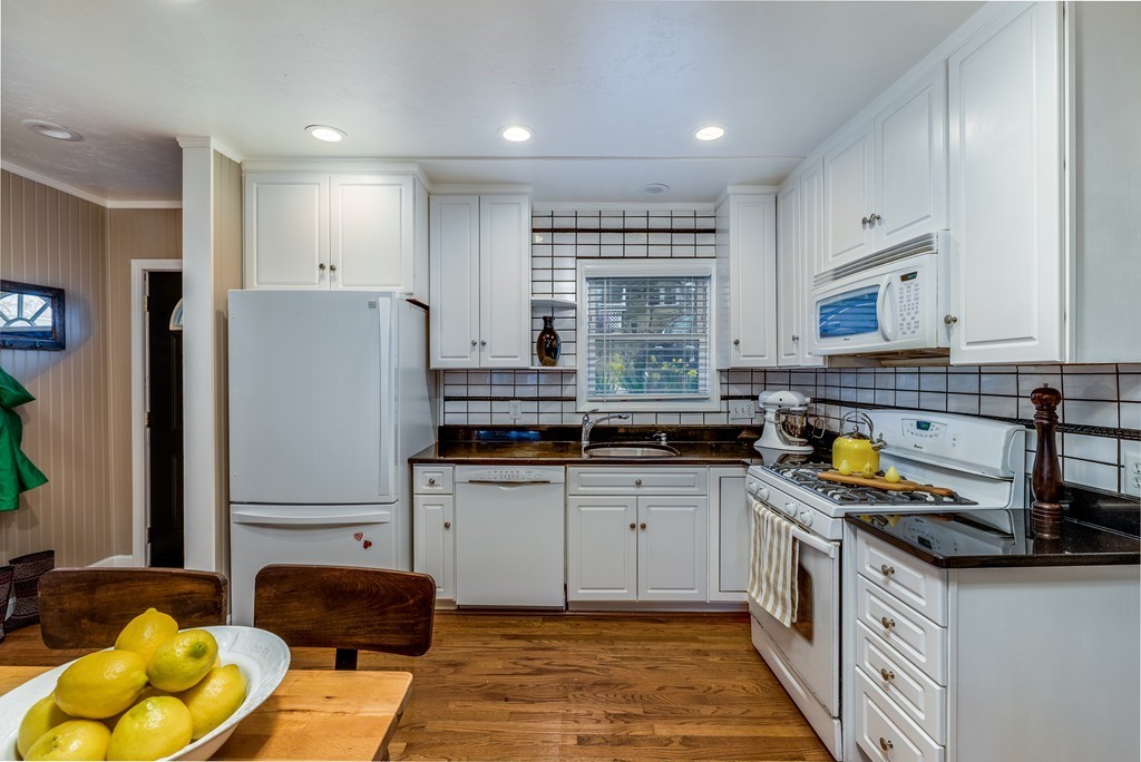 53 Colonial Road Weymouth, MA 02191 - Photo 4 of 19 a kitchen with stainless steel appliances granite countertop a sink a stove a refrigerator cabinets and a window