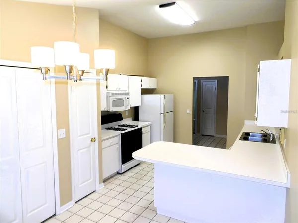a kitchen with stainless steel appliances a refrigerator sink and stove