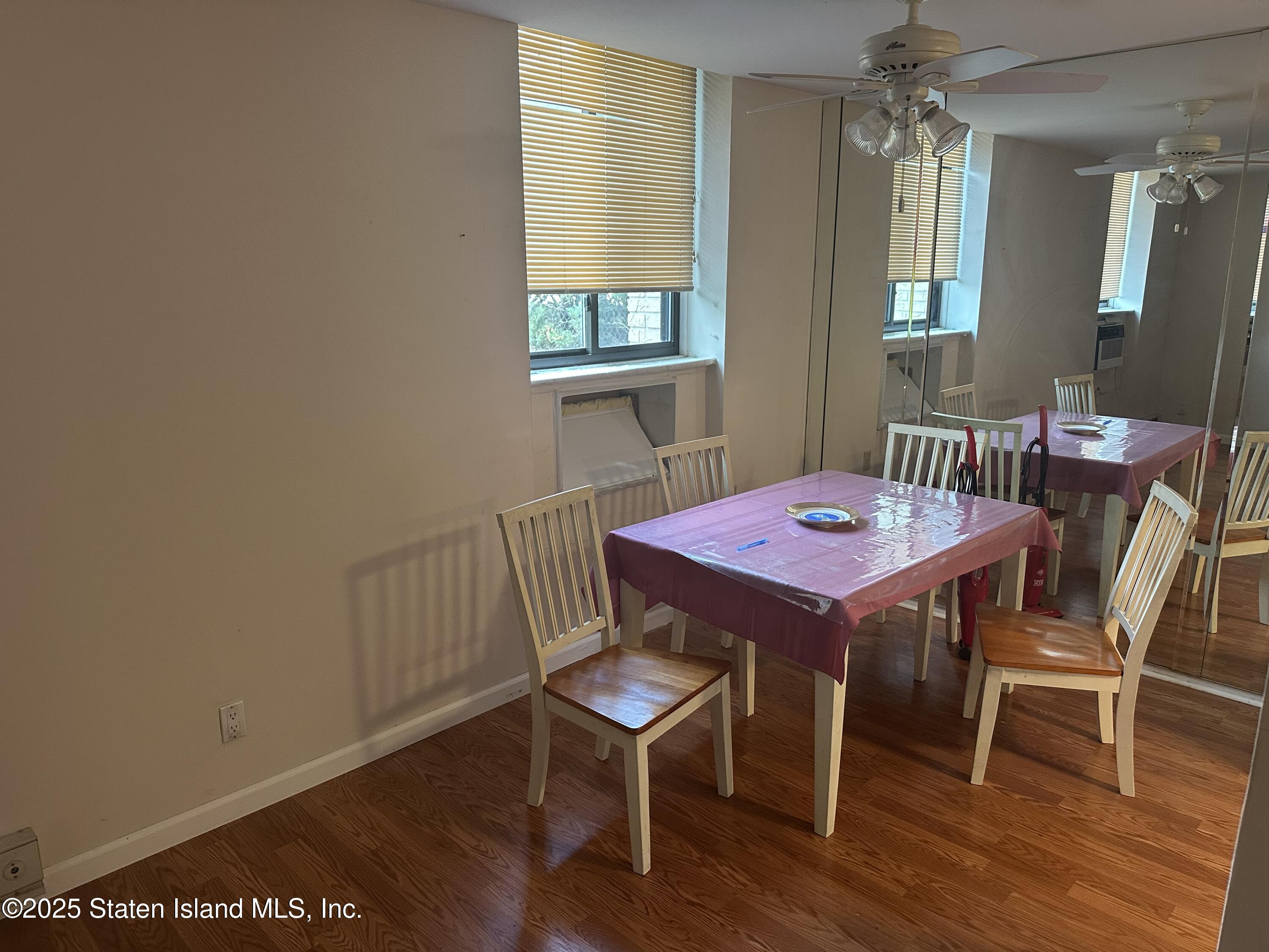 50 Belair Road, Unit 1E Staten Island, NY 10305 - Photo 5 of 12 a view of a dining room with furniture and wooden floor