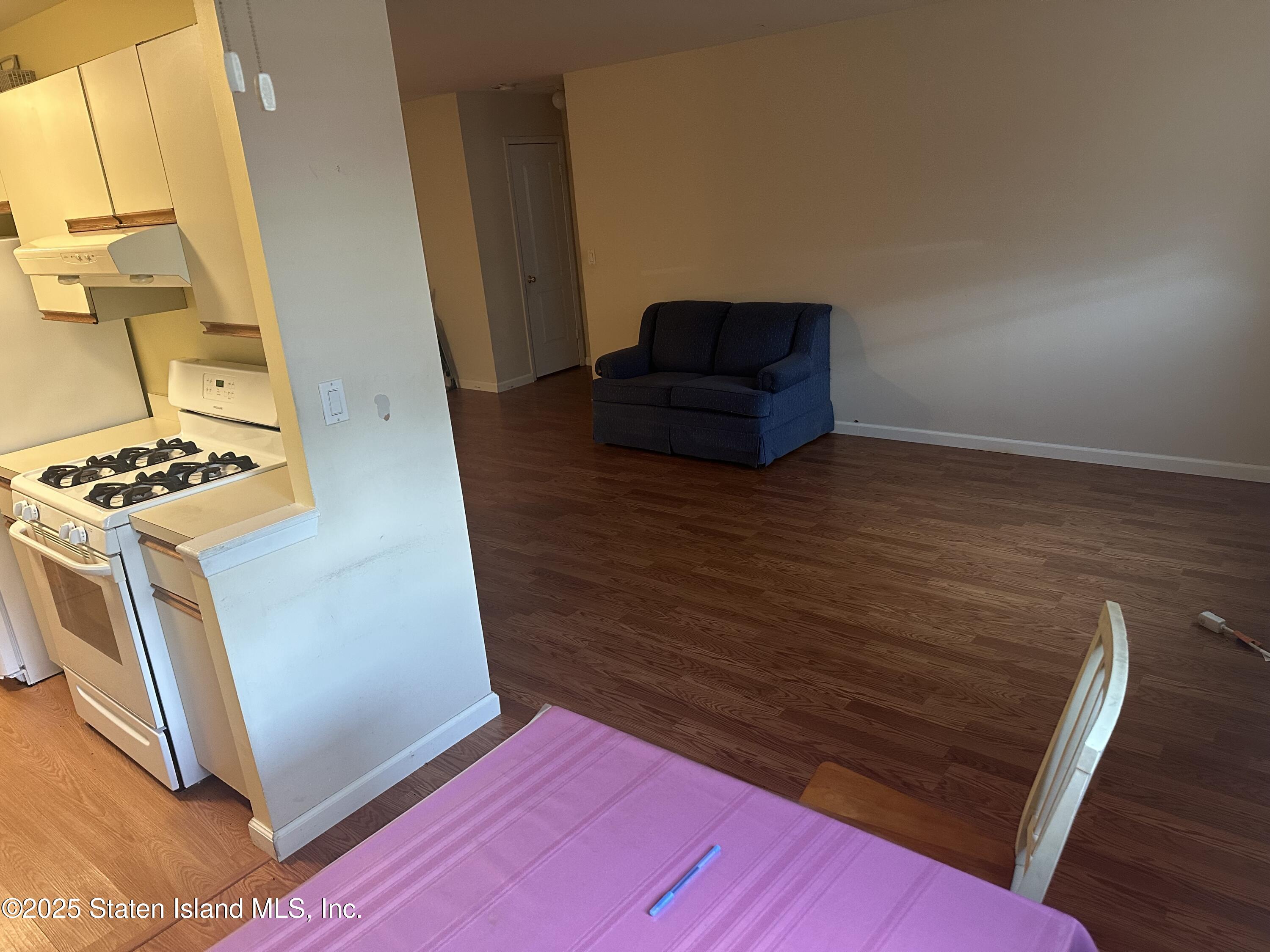 50 Belair Road, Unit 1E Staten Island, NY 10305 - Photo 6 of 12 a view of kitchen and wooden floor