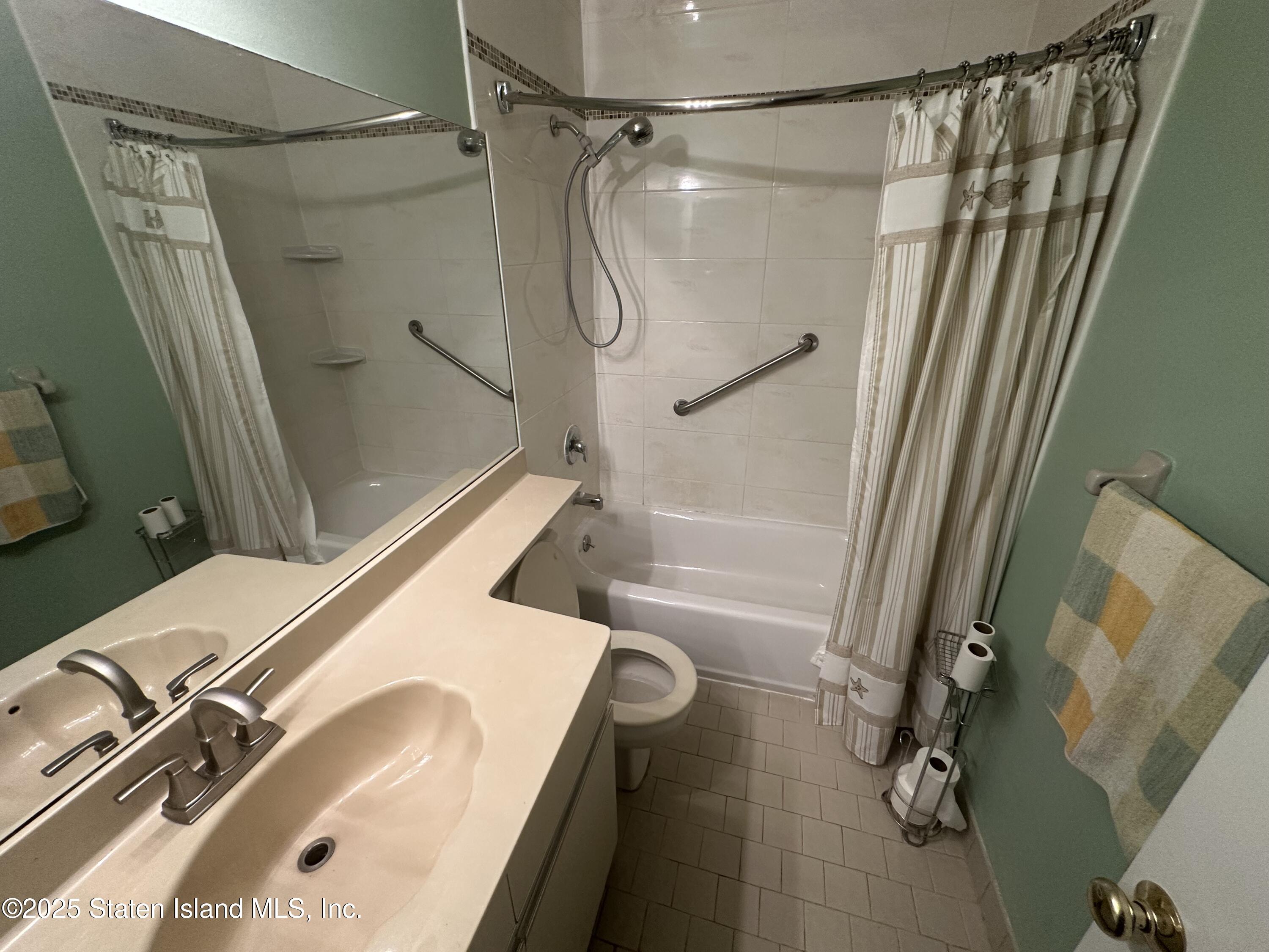 50 Belair Road, Unit 1E Staten Island, NY 10305 - Photo 8 of 12 a bathroom with a sink and a shower