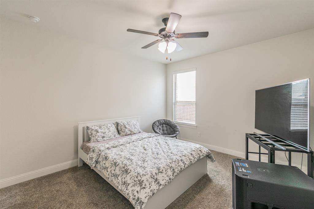 3424 Cimarron River Drive Prosper, TX 75078 - Photo 12 of 40 a bedroom with a bed and a flat screen tv