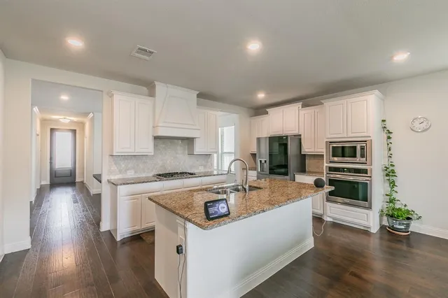 a kitchen with a stove a sink and a refrigerator