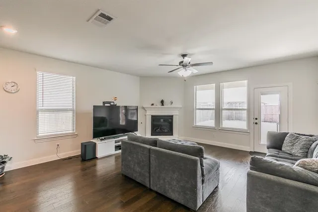 a living room with furniture fireplace and flat screen tv