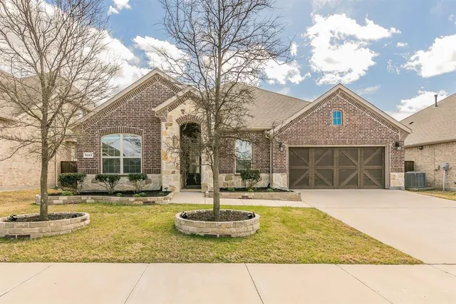 a front view of a house with a yard garage and outdoor seating