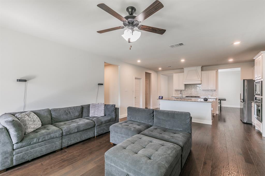 3424 Cimarron River Drive Prosper, TX 75078 - Photo 21 of 40 a living room with furniture kitchen view and a chandelier