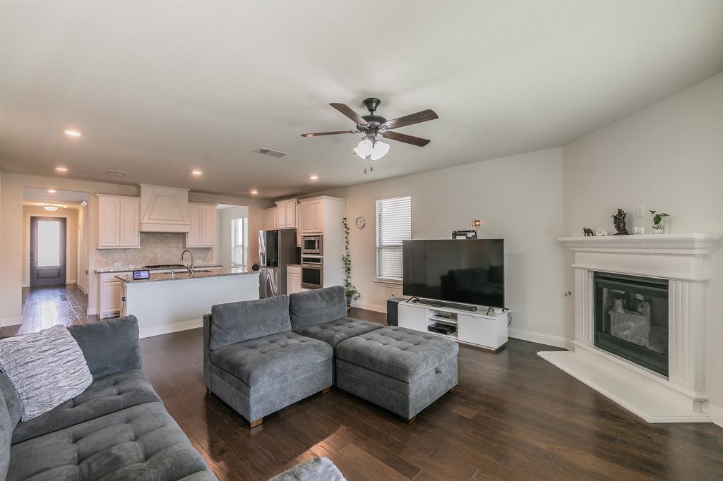 3424 Cimarron River Drive Prosper, TX 75078 - Photo 22 of 40 a living room with furniture fireplace and flat screen tv