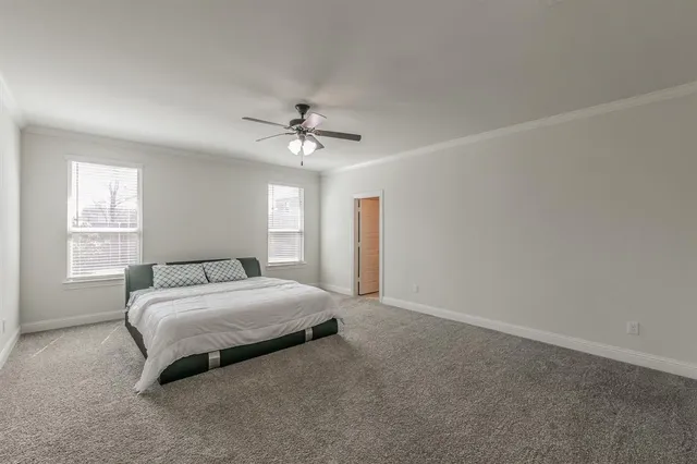a spacious bedroom with a bed and a chandelier
