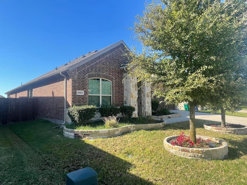 3424 Cimarron River Drive Prosper, TX 75078 - Photo 26 of 40 a front view of a house with a yard