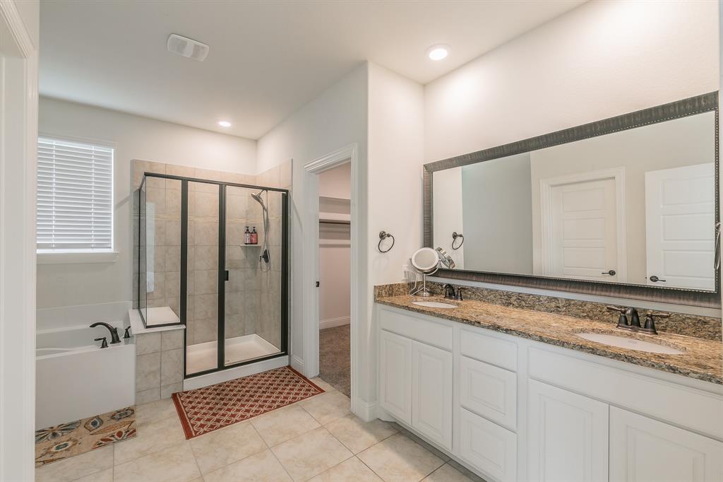 3424 Cimarron River Drive Prosper, TX 75078 - Photo 28 of 40 a spacious bathroom with a granite countertop sink a mirror and a bathtub