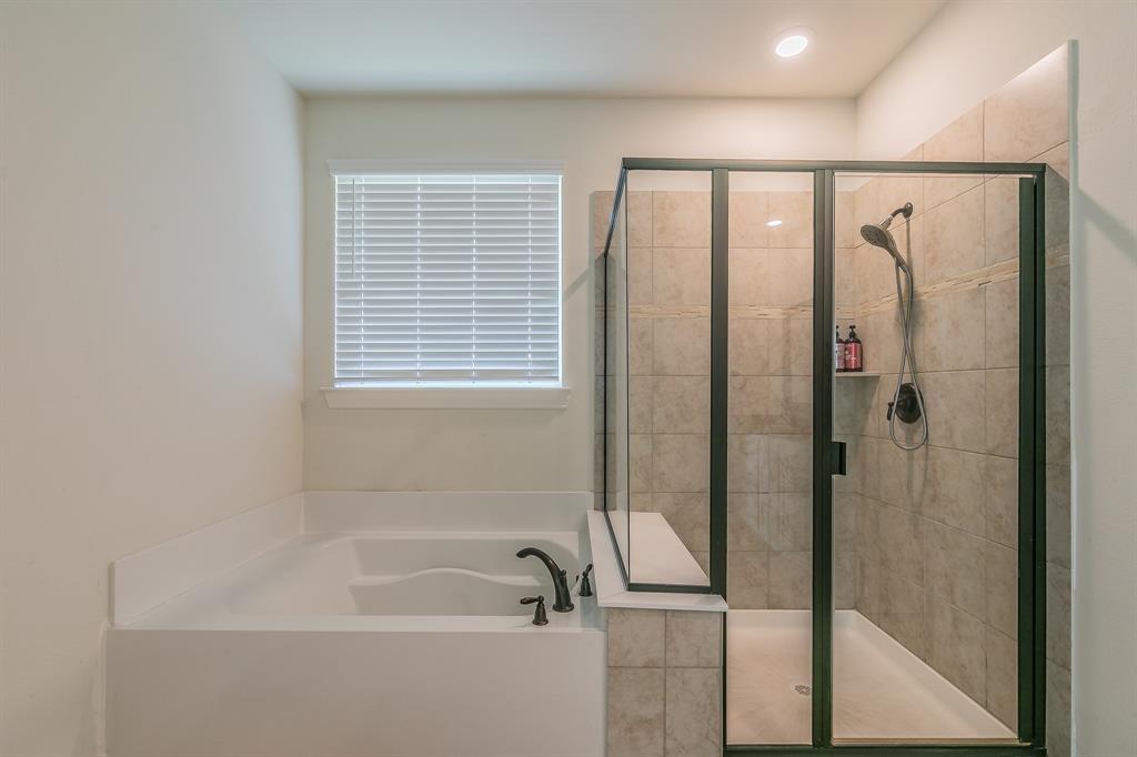 3424 Cimarron River Drive Prosper, TX 75078 - Photo 29 of 40 a bathroom with a bathtub and a shower
