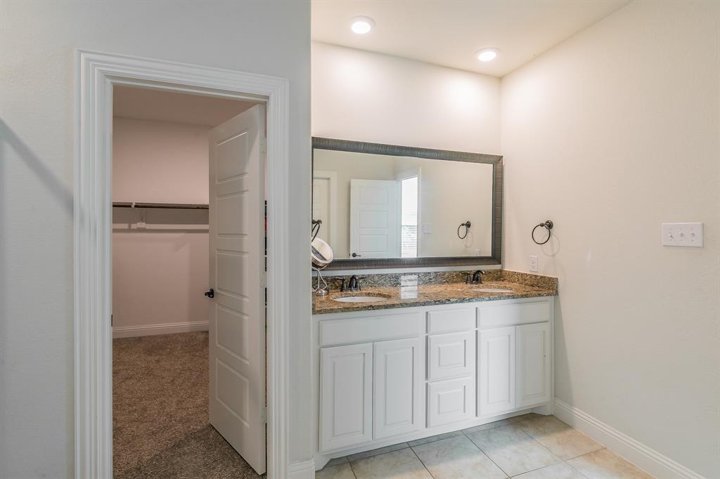 3424 Cimarron River Drive Prosper, TX 75078 - Photo 30 of 40 a bathroom with a granite countertop sink and a mirror