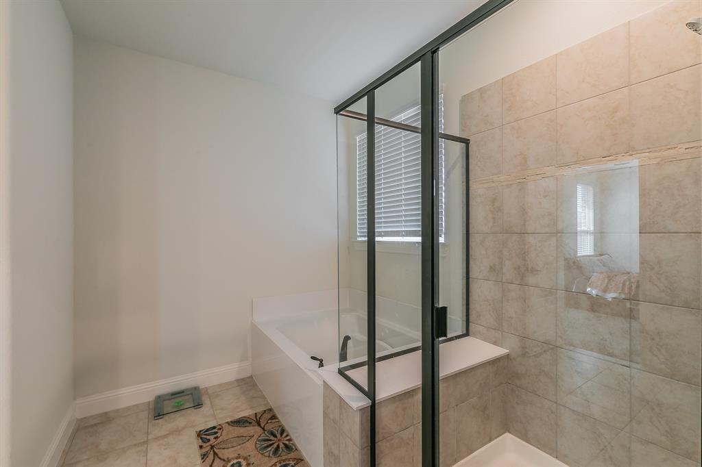 3424 Cimarron River Drive Prosper, TX 75078 - Photo 32 of 40 a bathroom with a bathtub and shower
