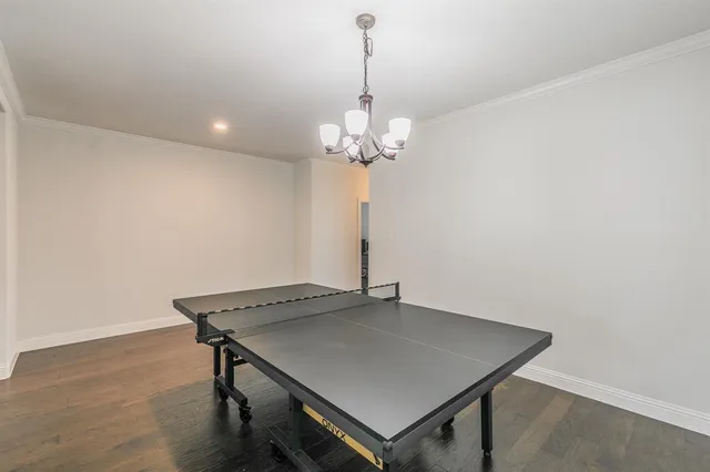 a view of a room with a table and chairs