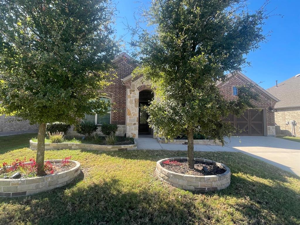 3424 Cimarron River Drive Prosper, TX 75078 - Photo 4 of 40 a outdoor space with a water fountain and a fire pit