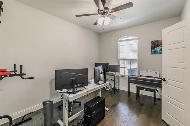 a view of a workspace with furniture and a window