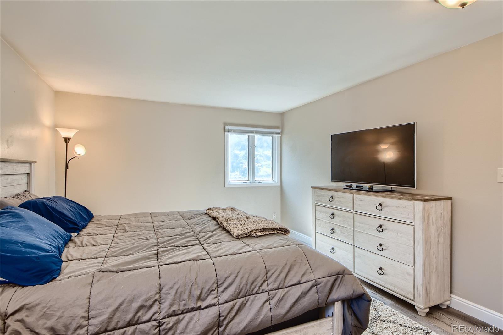 1500 Buckeye Circle Georgetown, CO 80444 - Photo 13 of 33 a bedroom with a bed and a flat screen tv