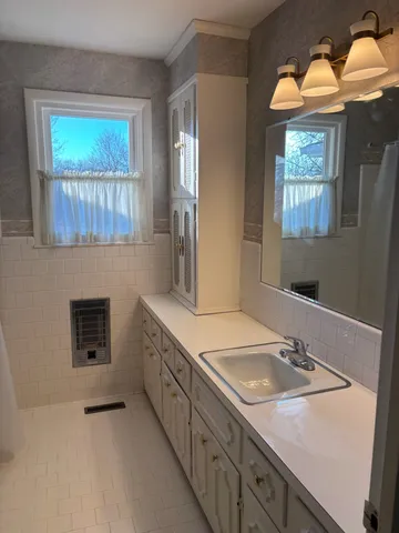 a bathroom with a toilet sink and mirror