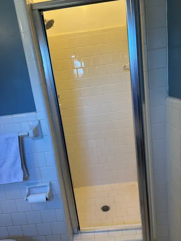 a view of a hallway with wooden floor and closet