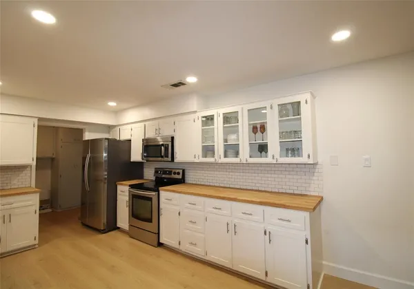 a kitchen with stainless steel appliances a refrigerator stove and microwave