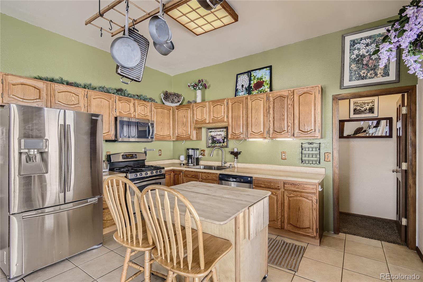 1749 County Road 72 Bailey, CO 80421 - Photo 11 of 35 a kitchen with stainless steel appliances granite countertop a refrigerator oven a sink a stove and island