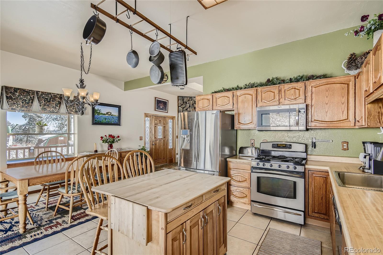 1749 County Road 72 Bailey, CO 80421 - Photo 12 of 35 a kitchen with stainless steel appliances granite countertop a stove a sink a refrigerator and a wooden cabinets