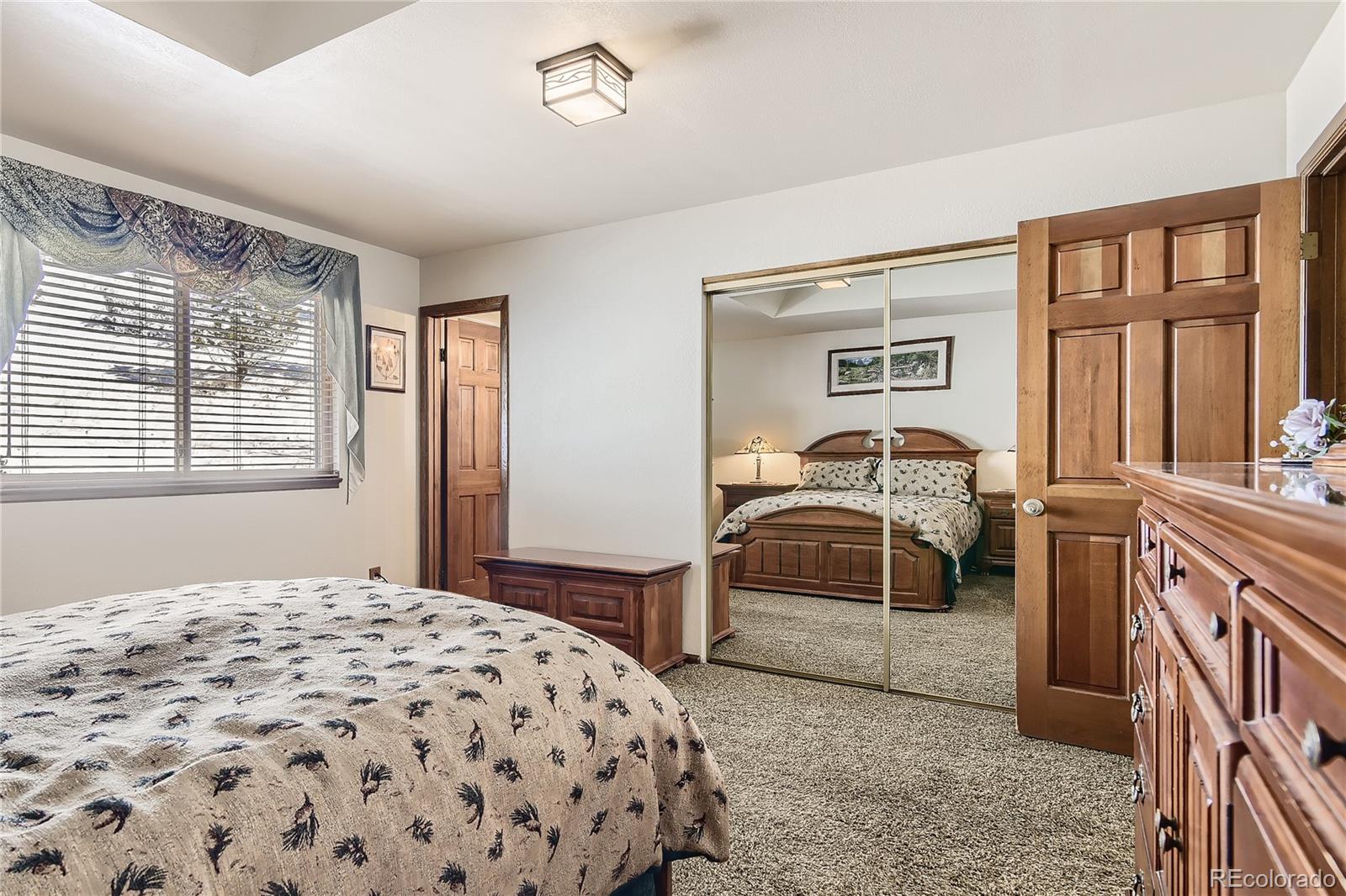 1749 County Road 72 Bailey, CO 80421 - Photo 14 of 35 a bedroom with a bed and a large window