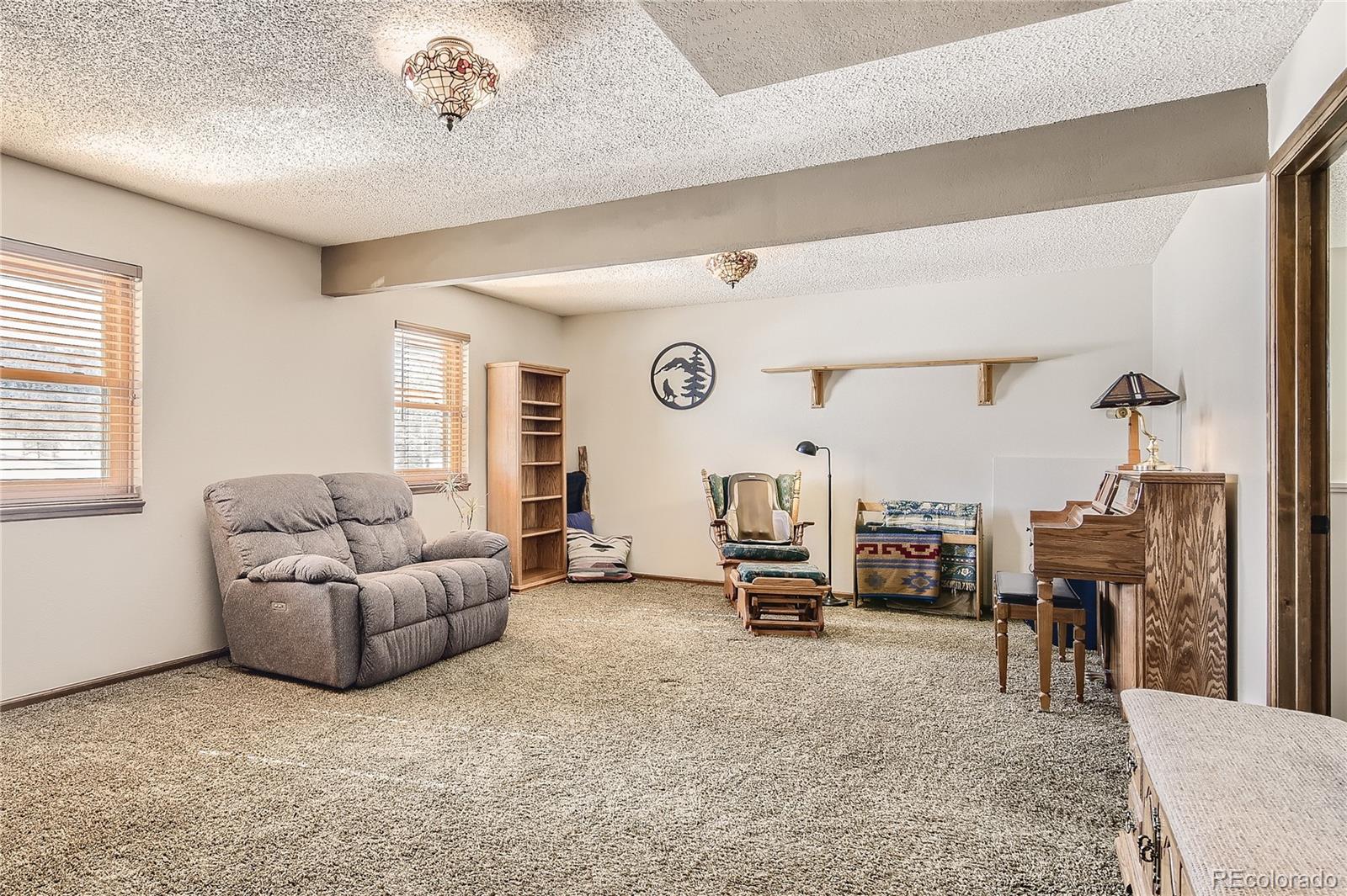 1749 County Road 72 Bailey, CO 80421 - Photo 19 of 35 a living room with furniture and a large window