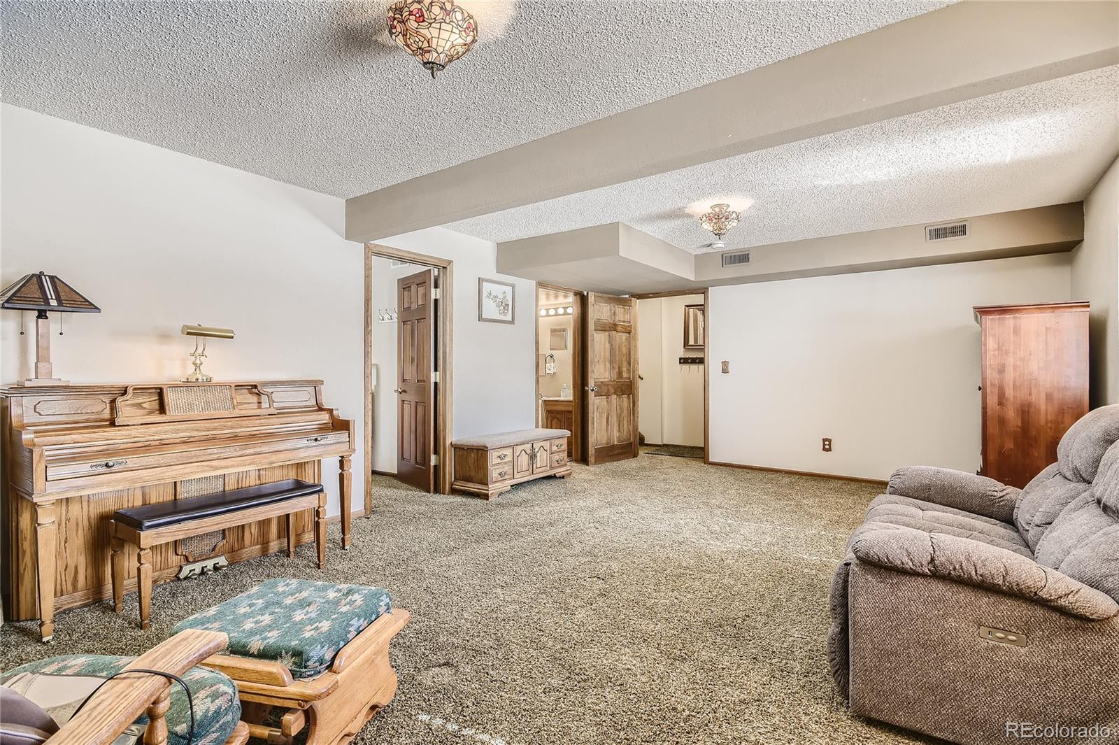 1749 County Road 72 Bailey, CO 80421 - Photo 20 of 35 a living room with furniture and a piano